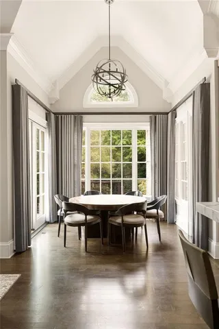 a bedroom with a bed and glass walk in closet