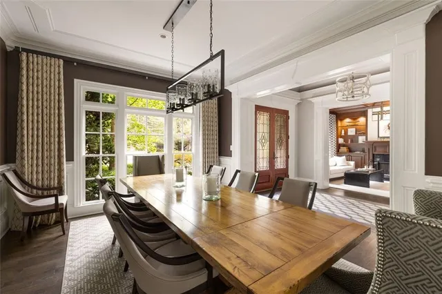 a living room with furniture large window and wooden floor