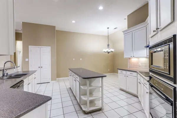 a kitchen with stainless steel appliances granite countertop a sink and a stove