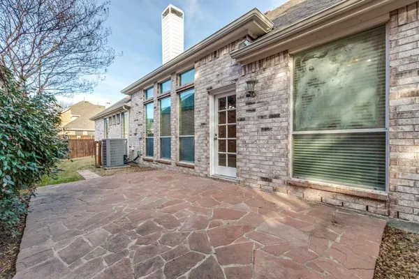a view of house with backyard and glass windows