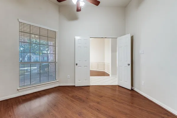wooden floor in an empty room with a window