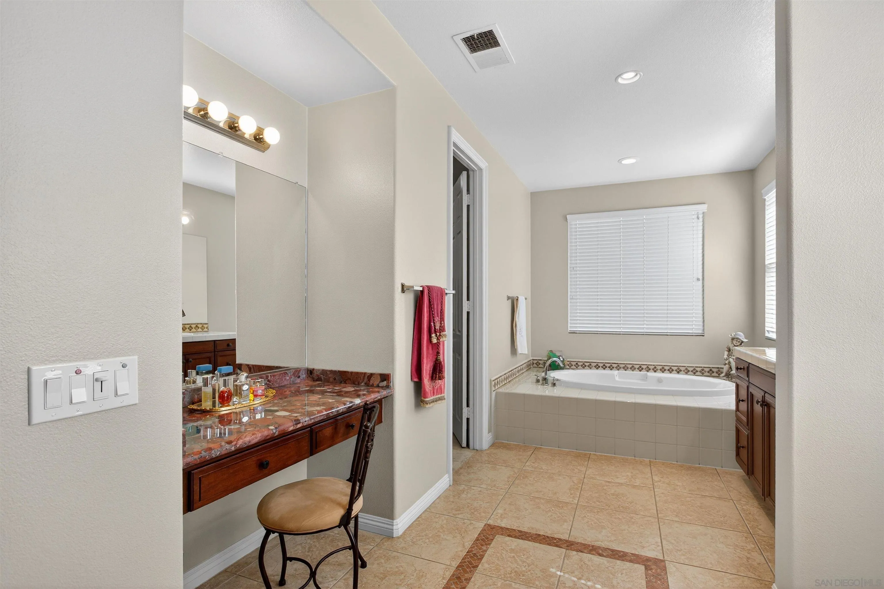 18410 Lakepointe Drive Riverside, CA 92503 - Photo 42 of 73 a en suite bathroom with a tub and a sink