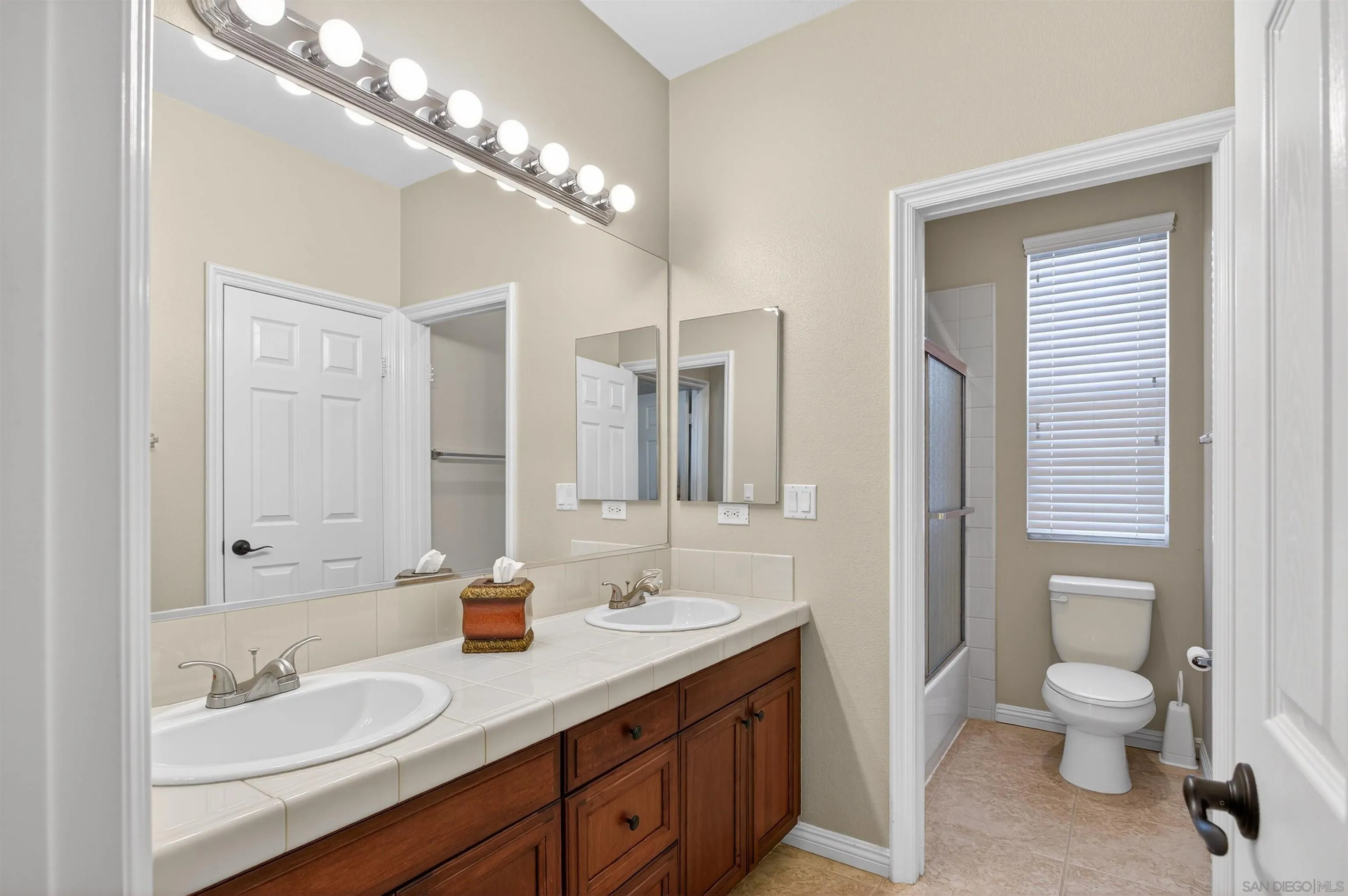 18410 Lakepointe Drive Riverside, CA 92503 - Photo 48 of 73 a spacious bathroom with a granite countertop sink a toilet and a mirror