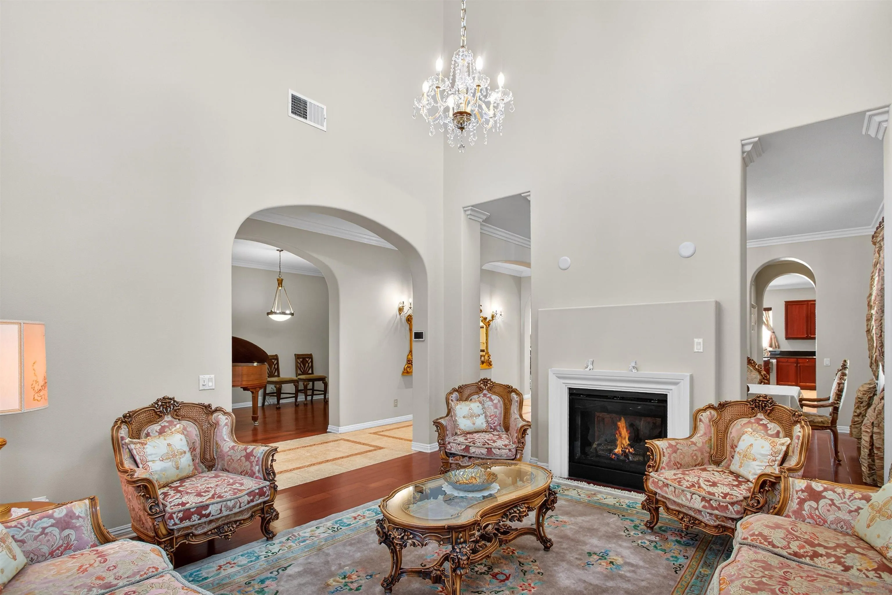 18410 Lakepointe Drive Riverside, CA 92503 - Photo 10 of 73 a living room with furniture a fireplace and a chandelier