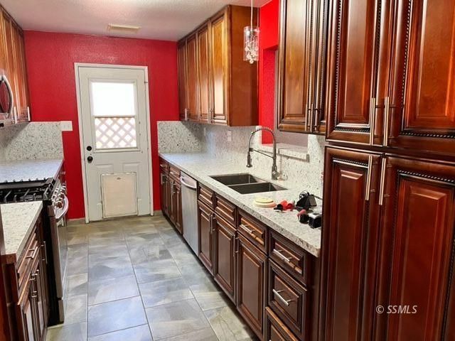 305 South Silver Ridge Street Ridgecrest, CA 93555 - Photo 5 of 32 a kitchen that has a sink and a stove