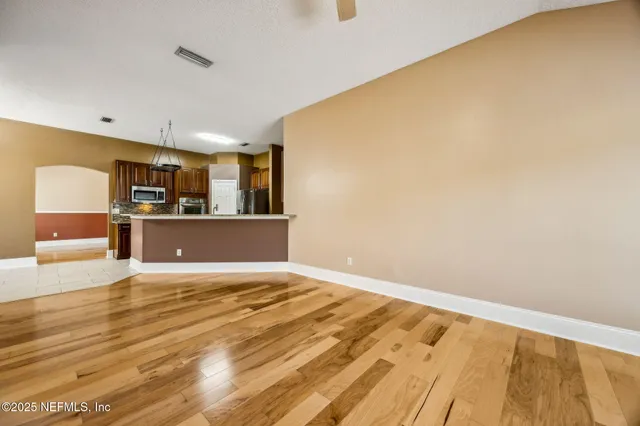 a spacious bathroom with a double vanity sink mirror and bathtub