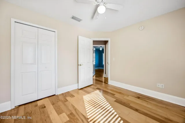 a front view of a house with a yard and potted plants