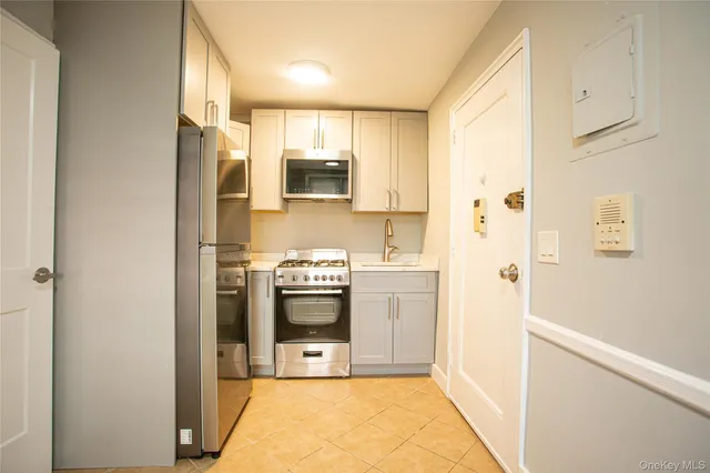 a kitchen with stainless steel appliances a refrigerator stove and sink