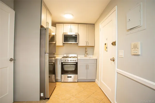 a kitchen with stainless steel appliances a refrigerator sink and stove