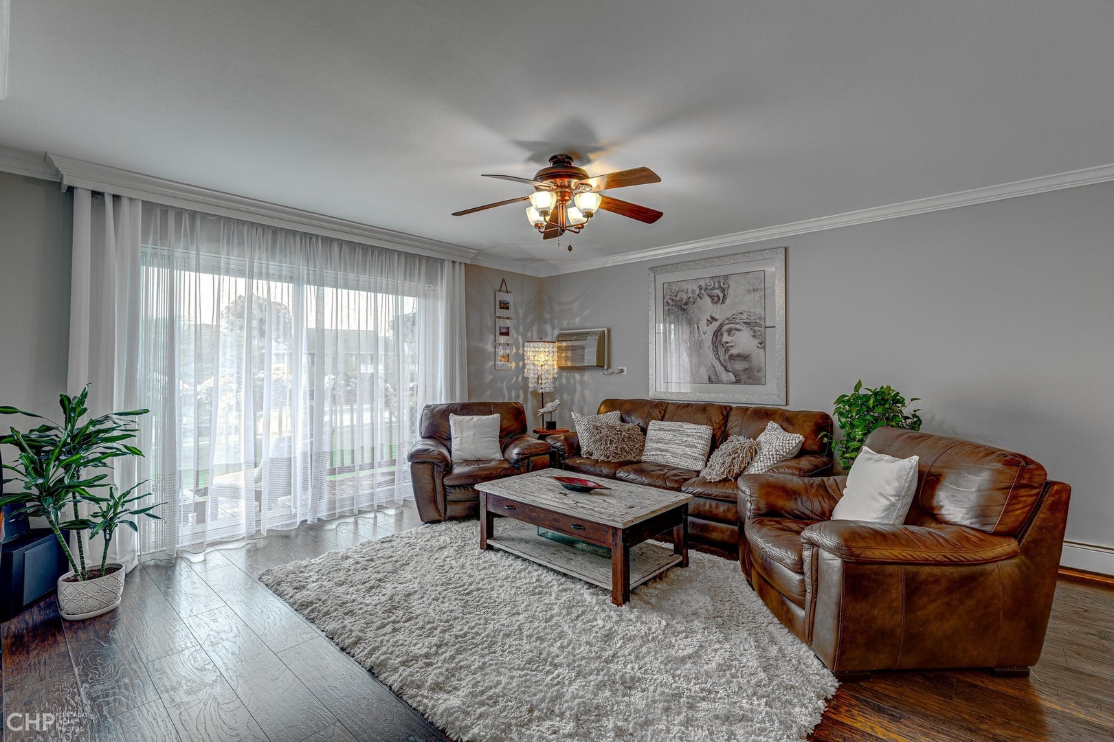 2222 South Goebbert Road, Unit 253 Arlington Heights, IL 60005 - Photo 3 of 16 a living room with furniture and wooden floor