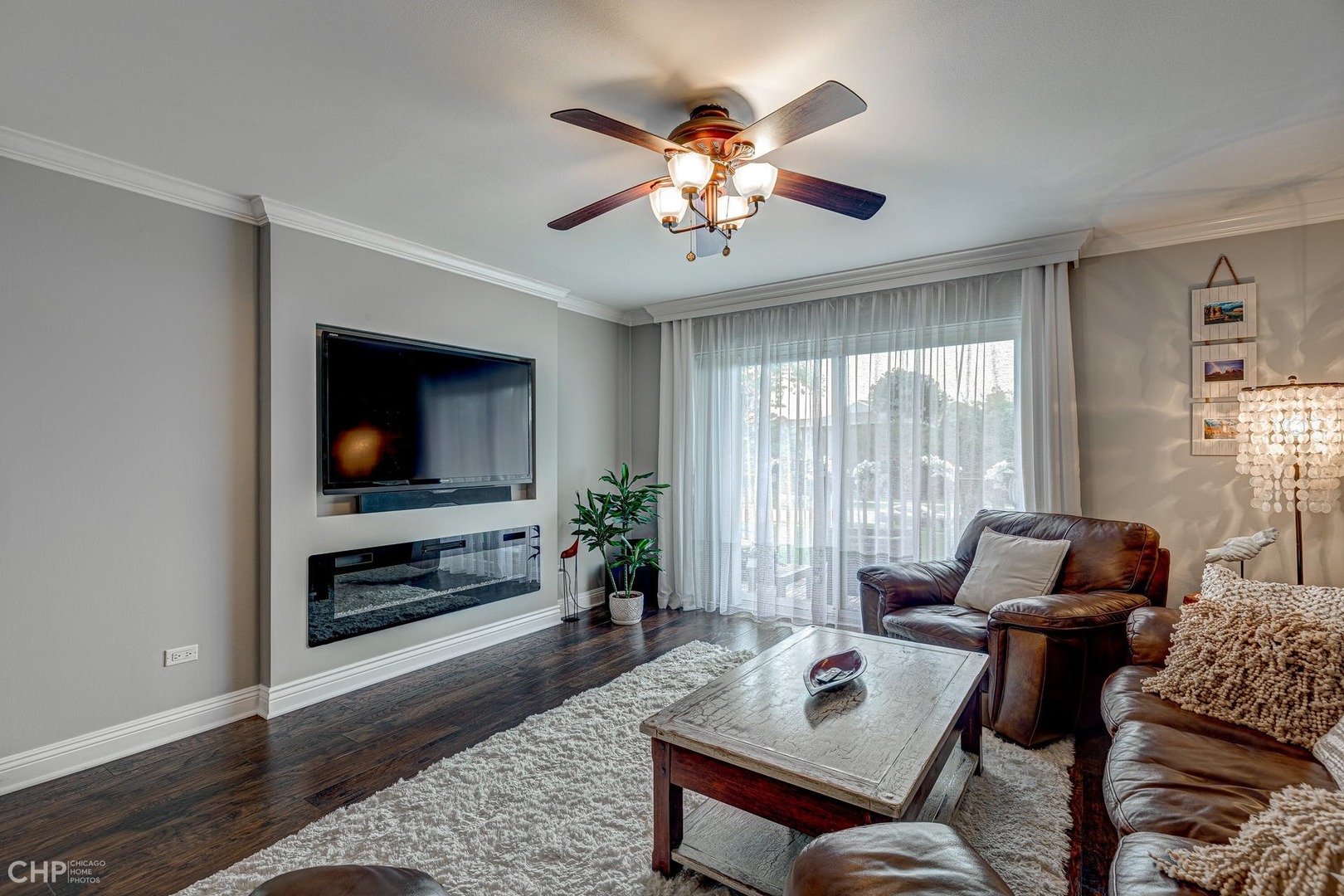 2222 South Goebbert Road, Unit 253 Arlington Heights, IL 60005 - Photo 4 of 16 a living room with furniture a flat screen tv and a large window