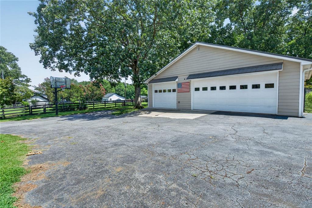 615 Tanner Road Dacula, GA 30019 - Photo 12 of 57 a view of a house with a yard and large trees