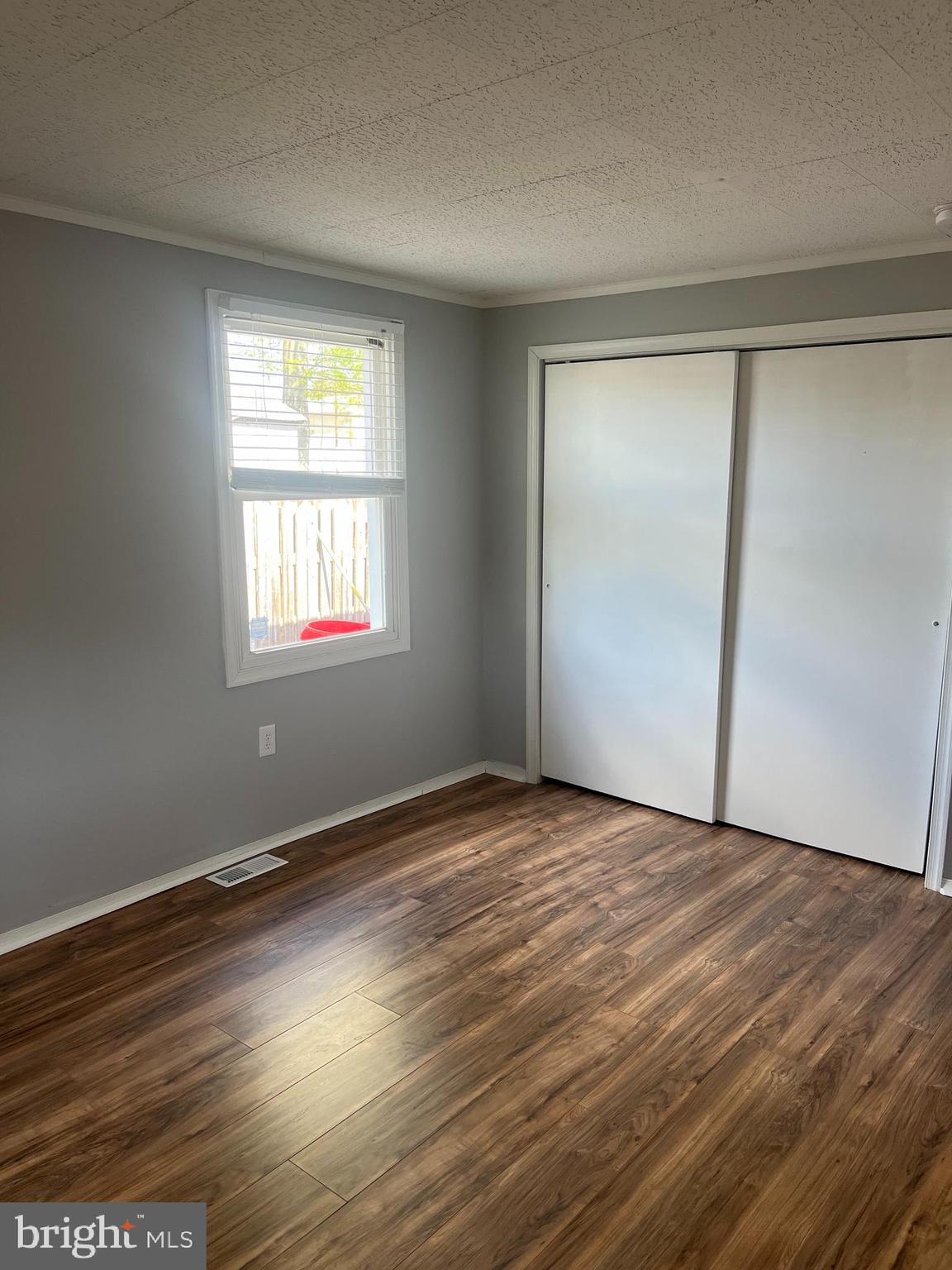 19 West Maiden Lane Somerdale, NJ 08083 - Photo 9 of 12 a view of an empty room with wooden floor and a window