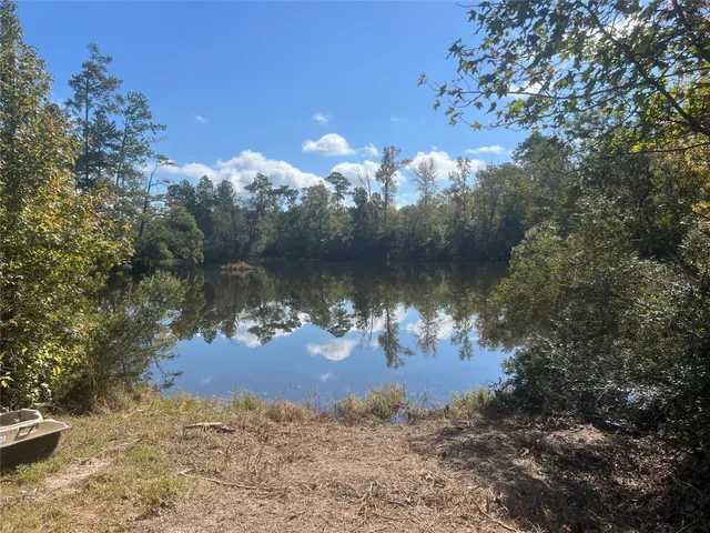 a view of a lake in between two of trees