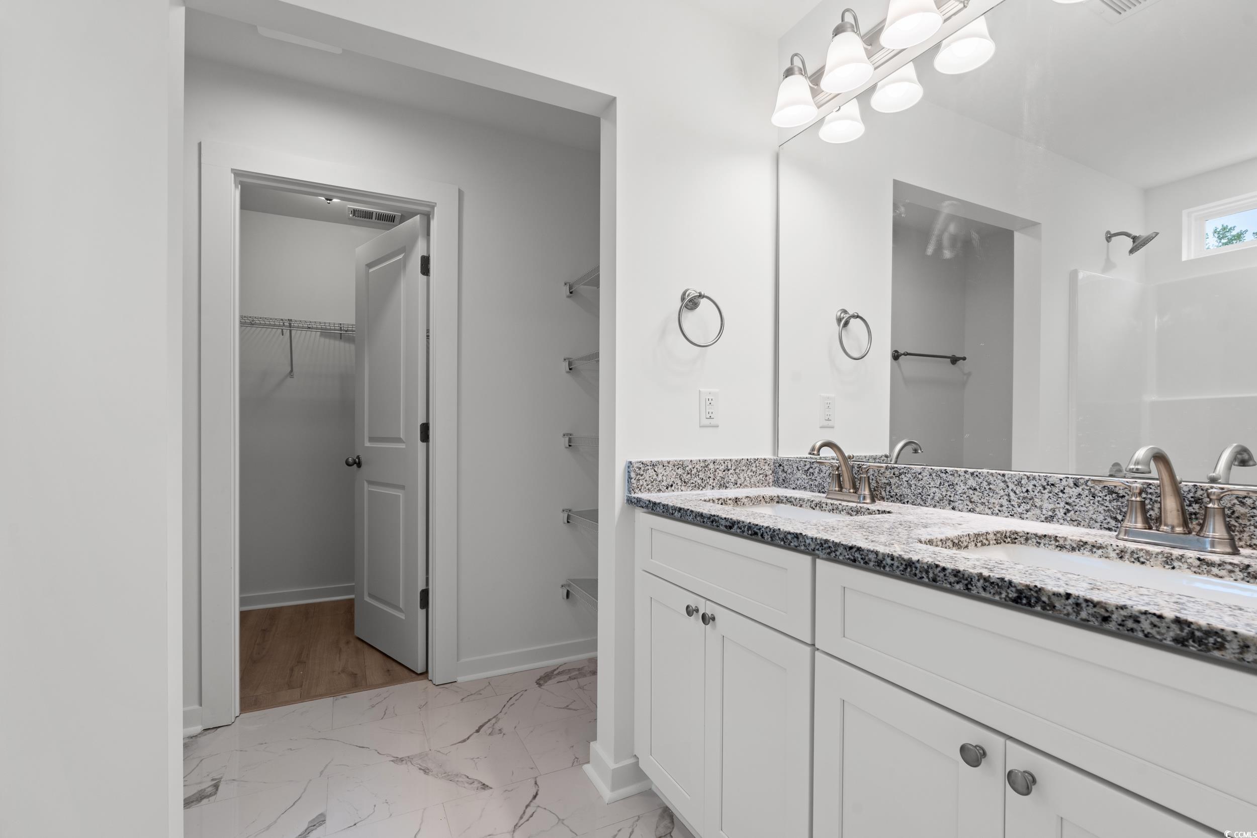 2827 Biscane Court Conway, SC 29527 - Photo 13 of 31 Full bath featuring light marble finish floors, a walk in closet, and double vanity
