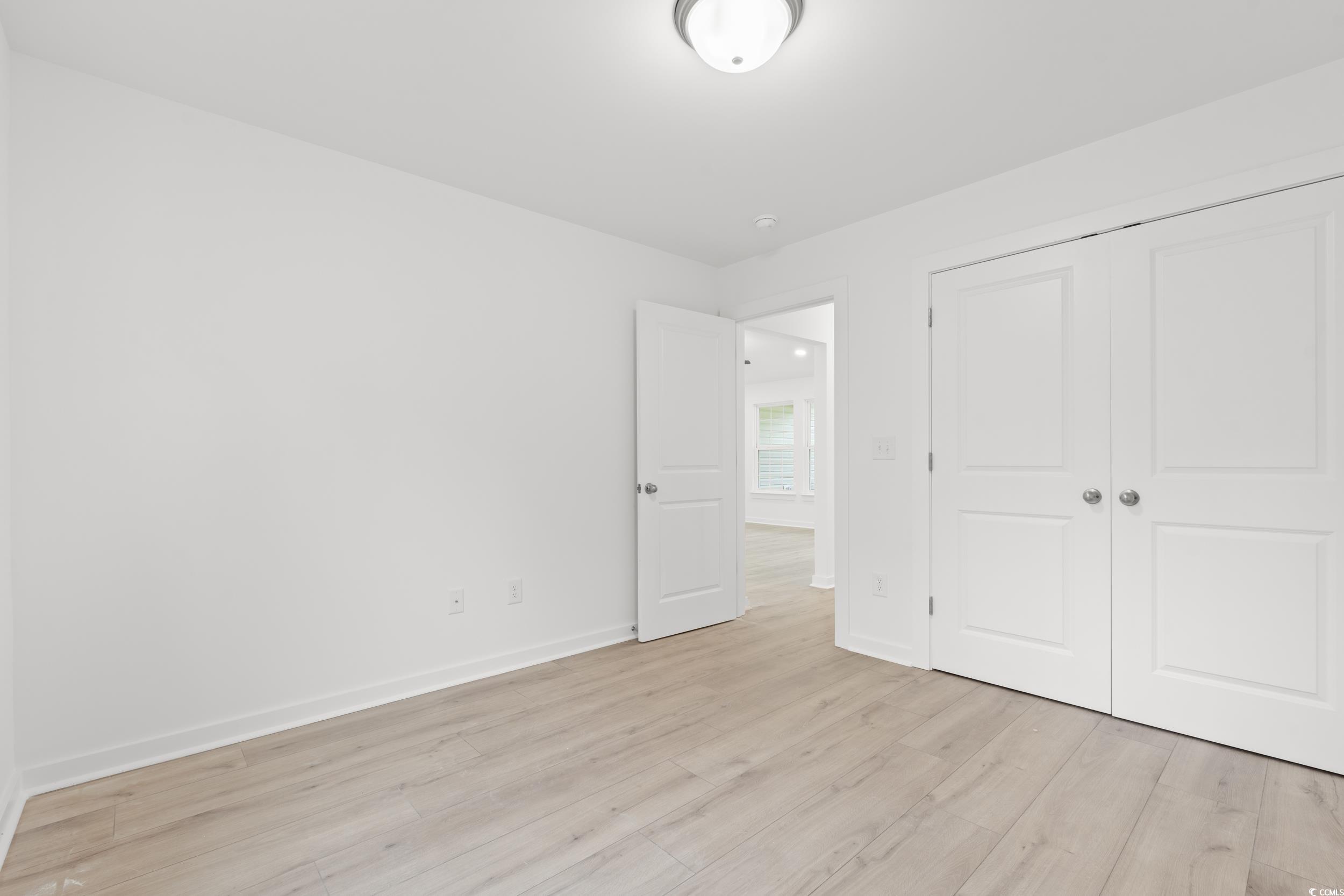 2827 Biscane Court Conway, SC 29527 - Photo 16 of 31 Unfurnished bedroom featuring light wood-type flooring and a closet