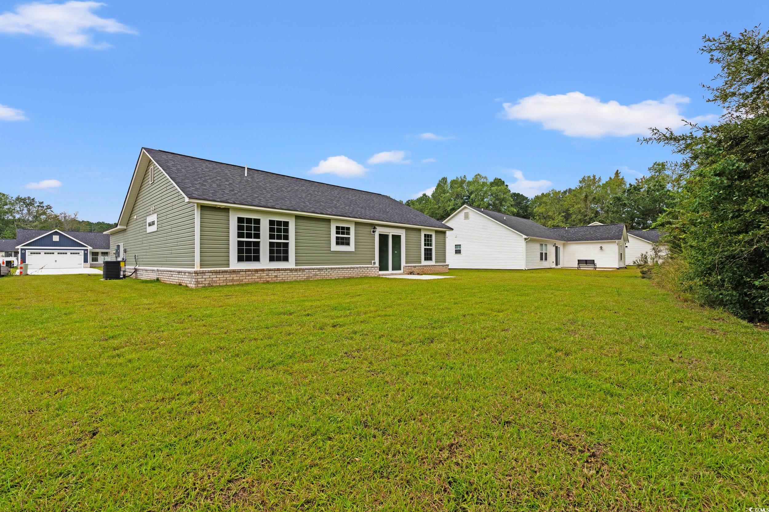 2827 Biscane Court Conway, SC 29527 - Photo 24 of 31 Rear view of property with a yard, roof with shingles, and a patio