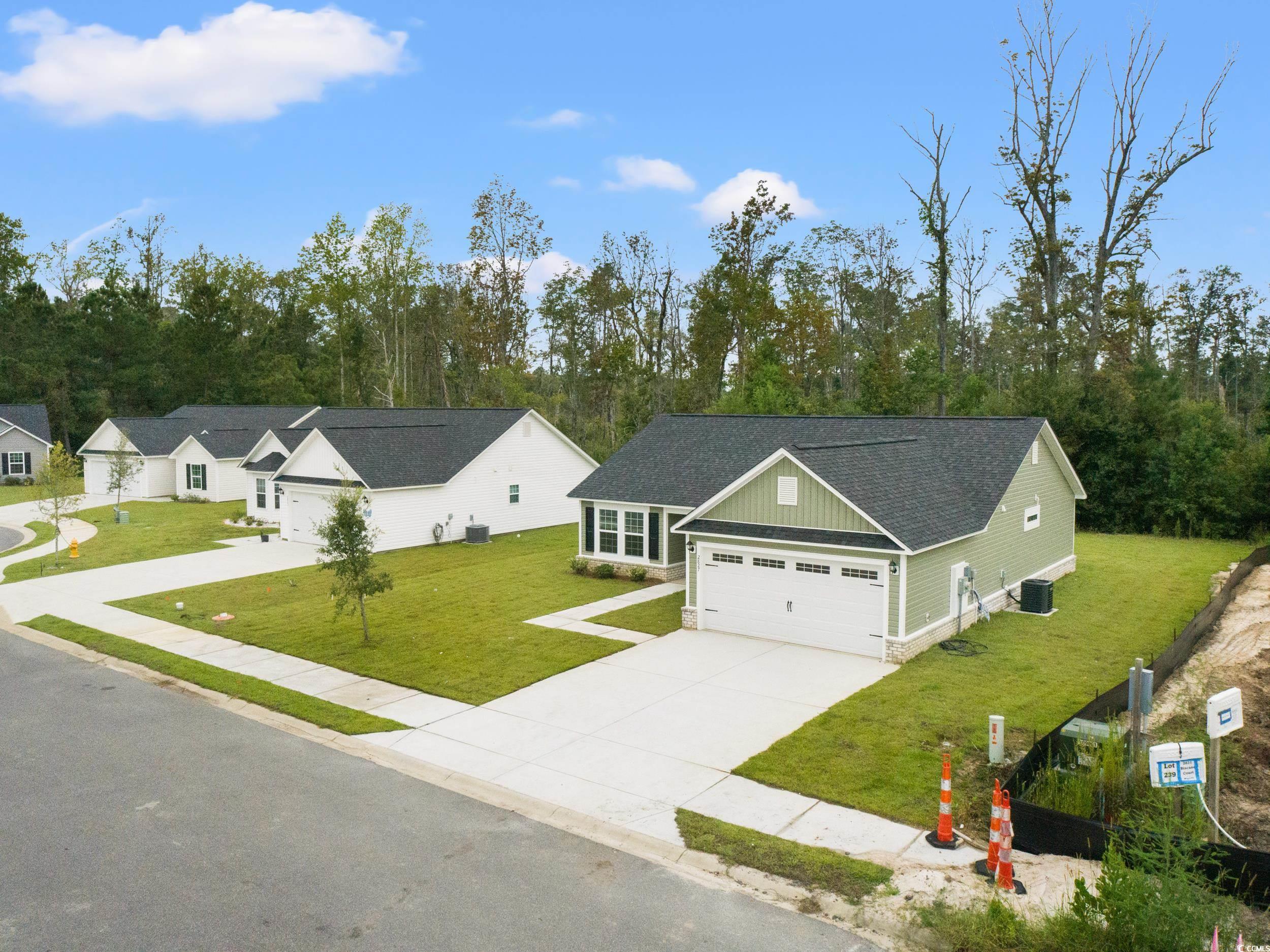 2827 Biscane Court Conway, SC 29527 - Photo 27 of 31 View of front facade with a front yard, concrete driveway, a garage, and a shingled roof