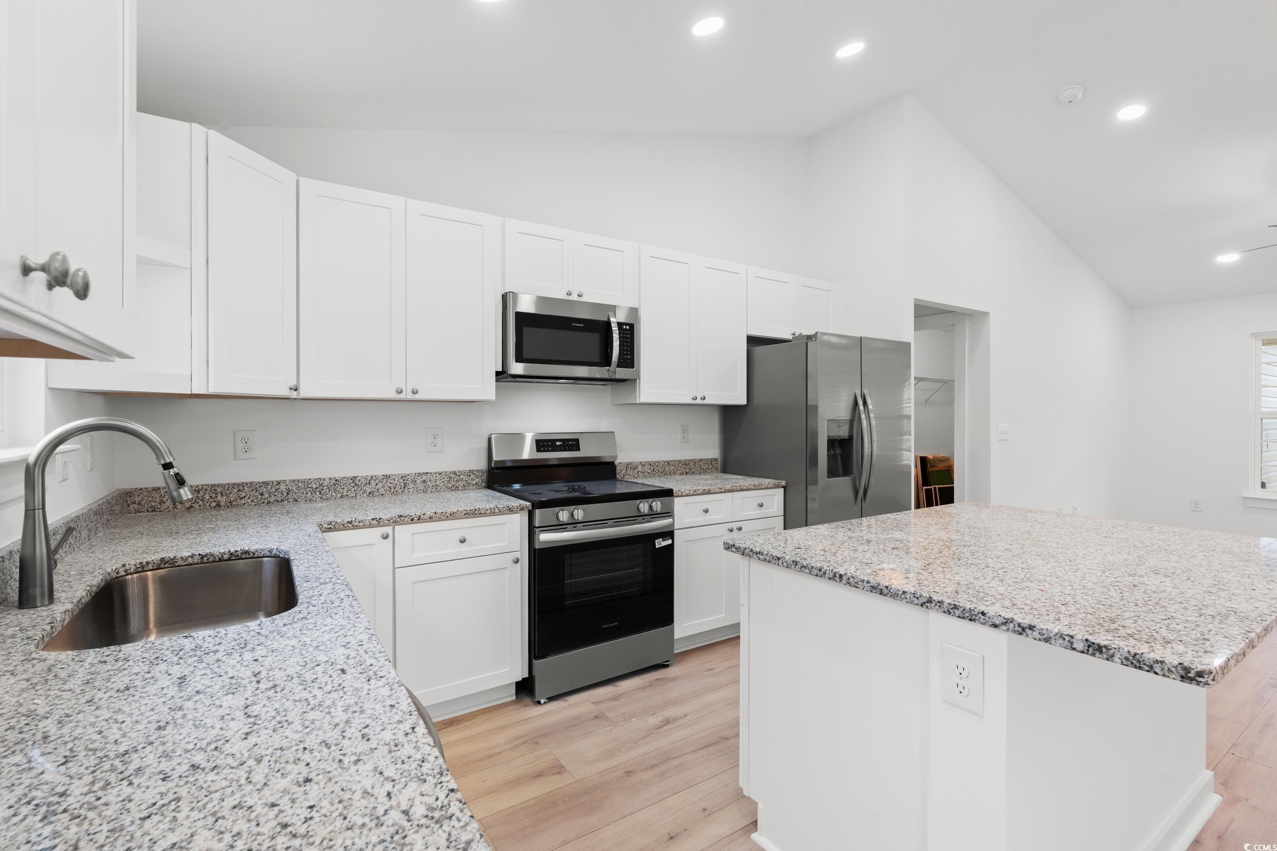 2827 Biscane Court Conway, SC 29527 - Photo 8 of 31 Kitchen featuring appliances with stainless steel finishes, a kitchen island, white cabinetry, light wood-type flooring, and recessed lighting