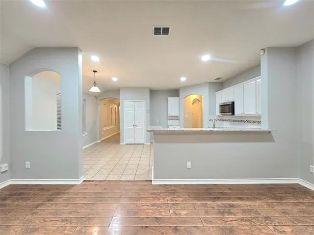 a view of kitchen with stainless steel appliances granite countertop a refrigerator a stove and a sink