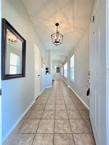 a view of a hallway with a chandelier