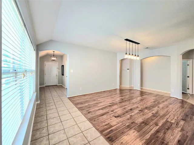 a view of empty room with wooden floor