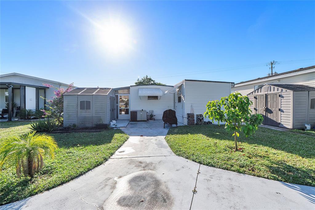 8631 Southwest 20th Street Davie, FL 33324 - Photo 15 of 21 a front view of a house with a yard and garage