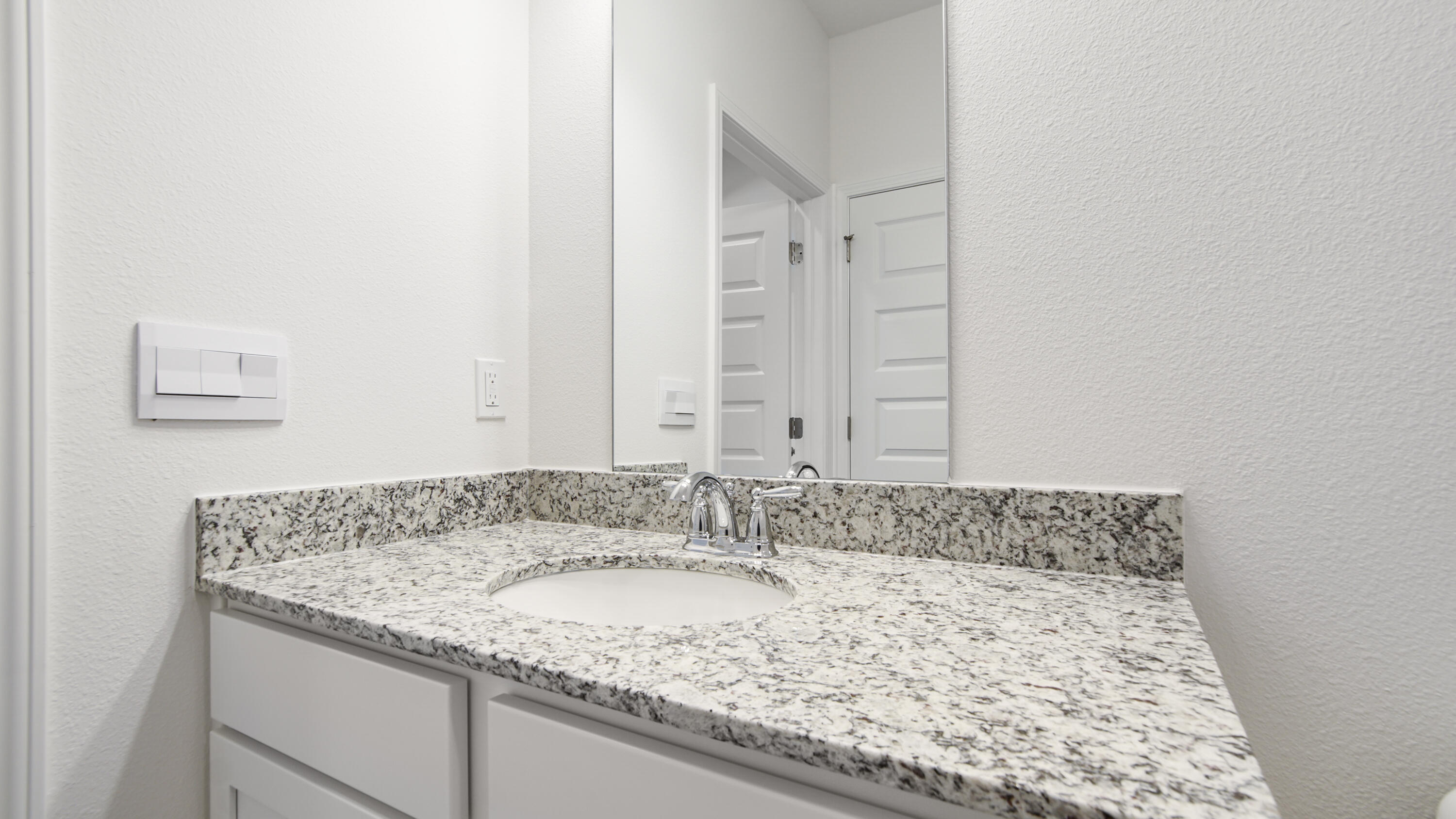 181 Huckleberry Street Freeport, FL 32439 - Photo 6 of 32 a bathroom with a granite countertop sink and a mirror
