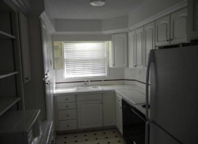 2040 Kings Gate Circle Southwest, Unit B Snellville, GA 30078 - Photo 2 of 7 a kitchen with a sink stove and refrigerator