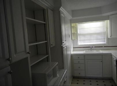 2040 Kings Gate Circle Southwest, Unit B Snellville, GA 30078 - Photo 4 of 7 a bathroom with a window sink and cabinets