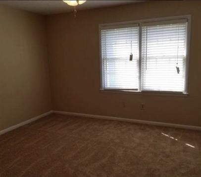 2040 Kings Gate Circle Southwest, Unit B Snellville, GA 30078 - Photo 5 of 7 an empty room with a window