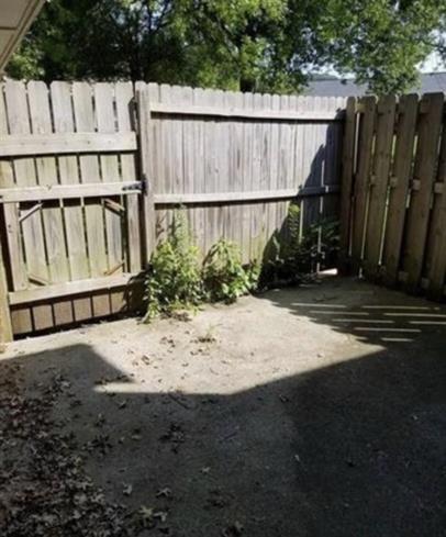 2040 Kings Gate Circle Southwest, Unit B Snellville, GA 30078 - Photo 7 of 7 a view of a house with backyard and wooden fence