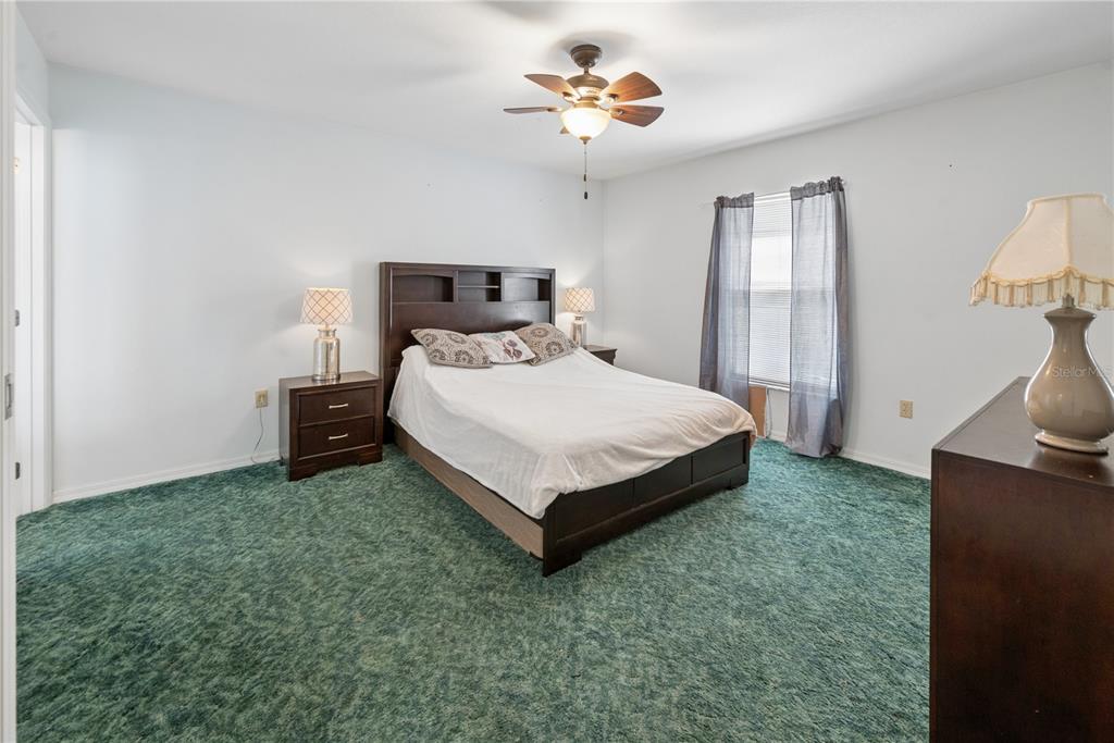 1750 Southwest 15th Street Bell, FL 32619 - Photo 14 of 34 a bedroom with a bed and a chandelier