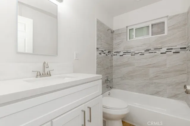 a bathroom with a sink a toilet and a bathtub