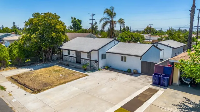 a view of a house with a yard and sitting area
