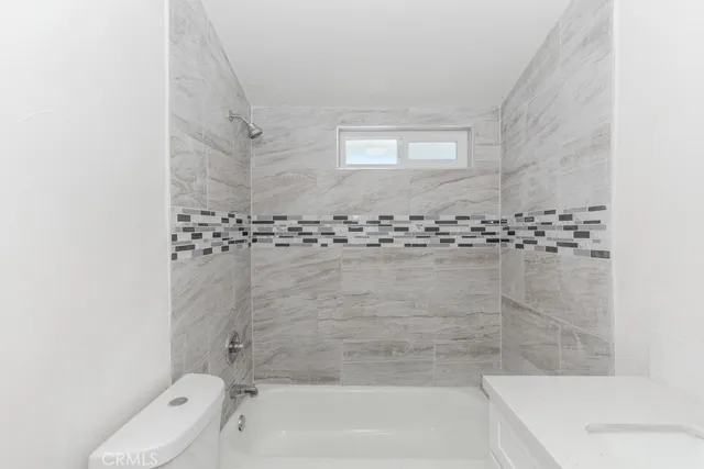 a bathroom with a bathtub and shower