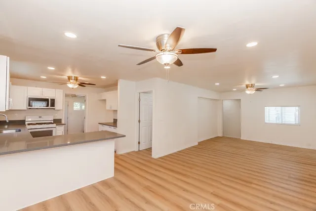 a view of kitchen with sink microwave and stove