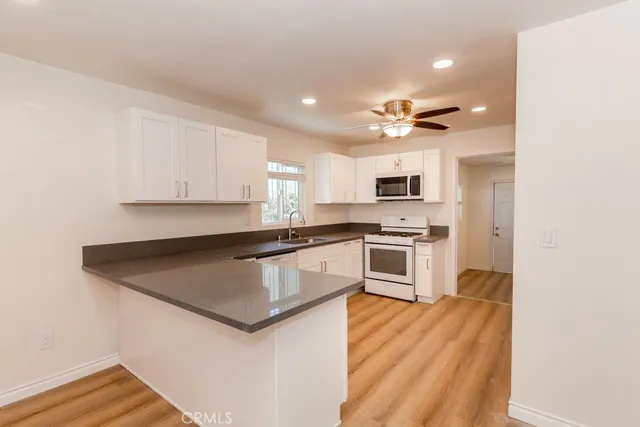 a kitchen with granite countertop a stove and a refrigerator