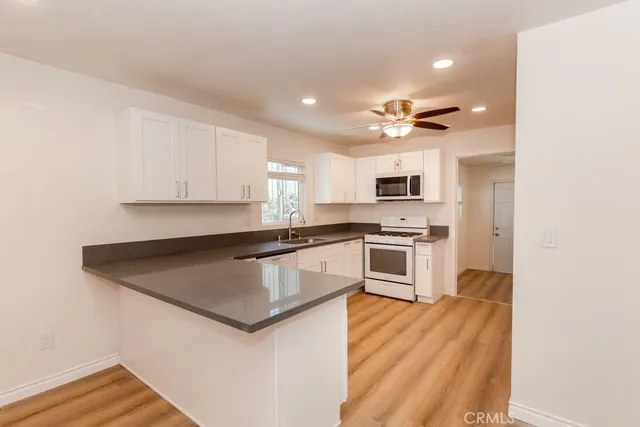 a kitchen with granite countertop a stove and a refrigerator