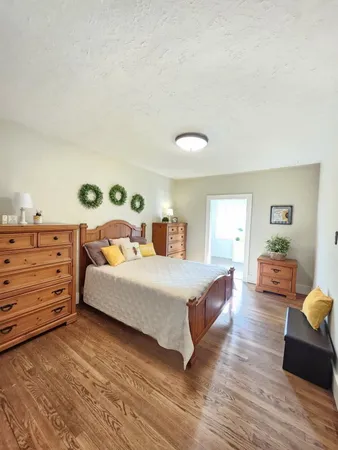 a spacious bedroom with a bed and a cabinets