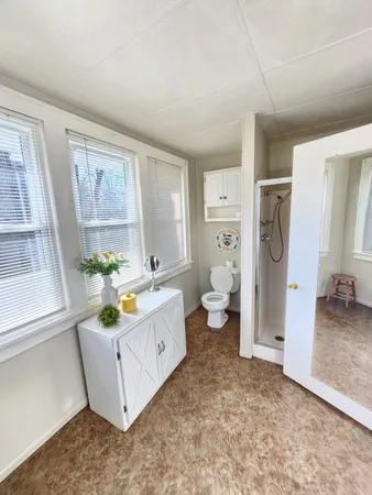 a room with a window wooden floor and a ceiling fan