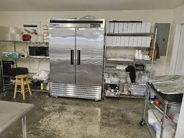 a view of a yard with trees in the background