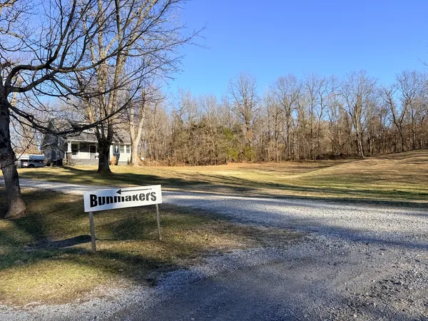 a wooden bench sitting in front of a house