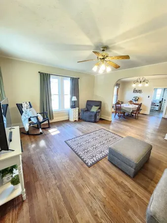 a living room with furniture and wooden floor