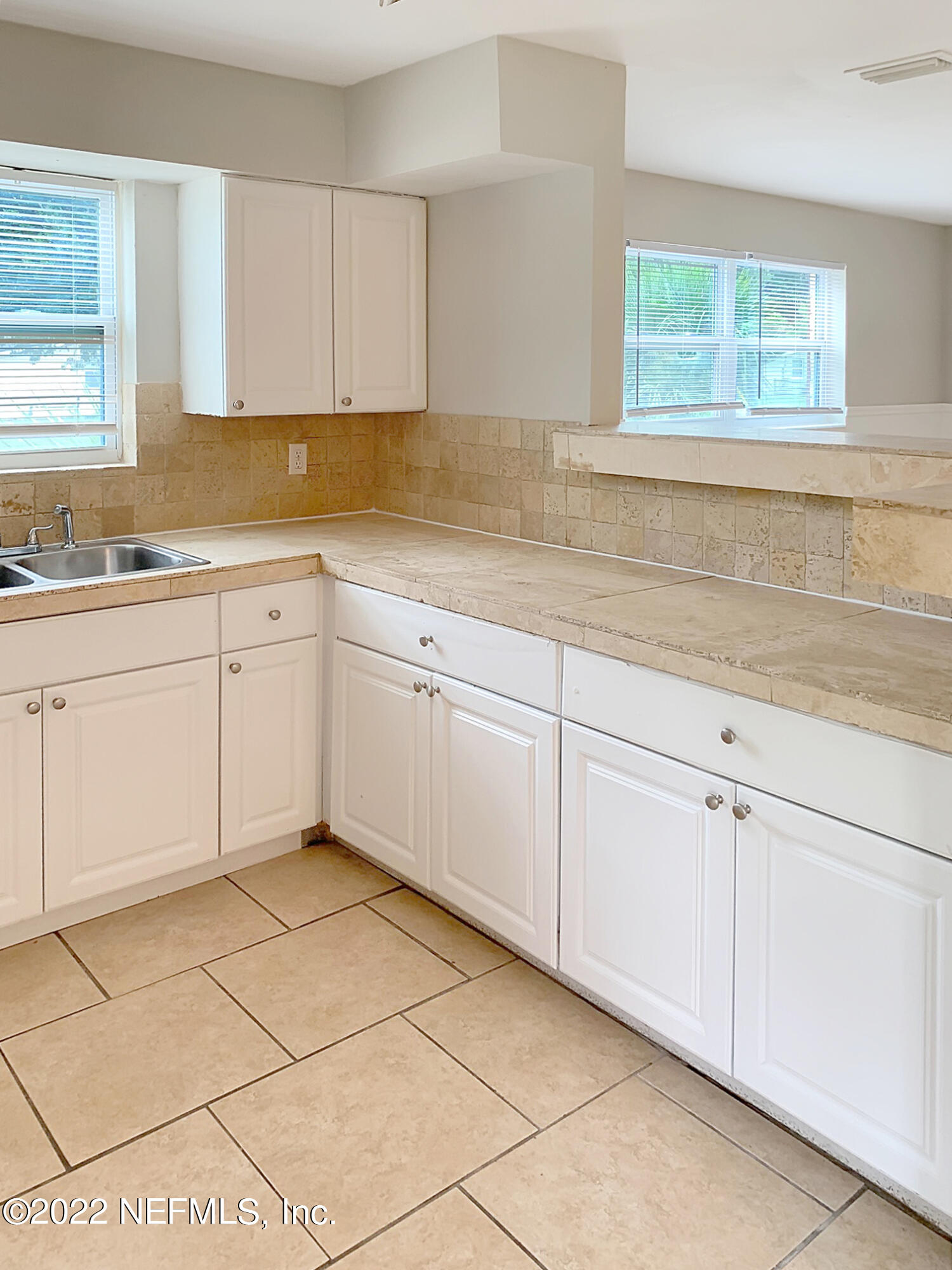 2950 Mansion Road Jacksonville, FL 32277 - Photo 15 of 30 a kitchen with granite countertop white cabinets white appliances a sink and a window