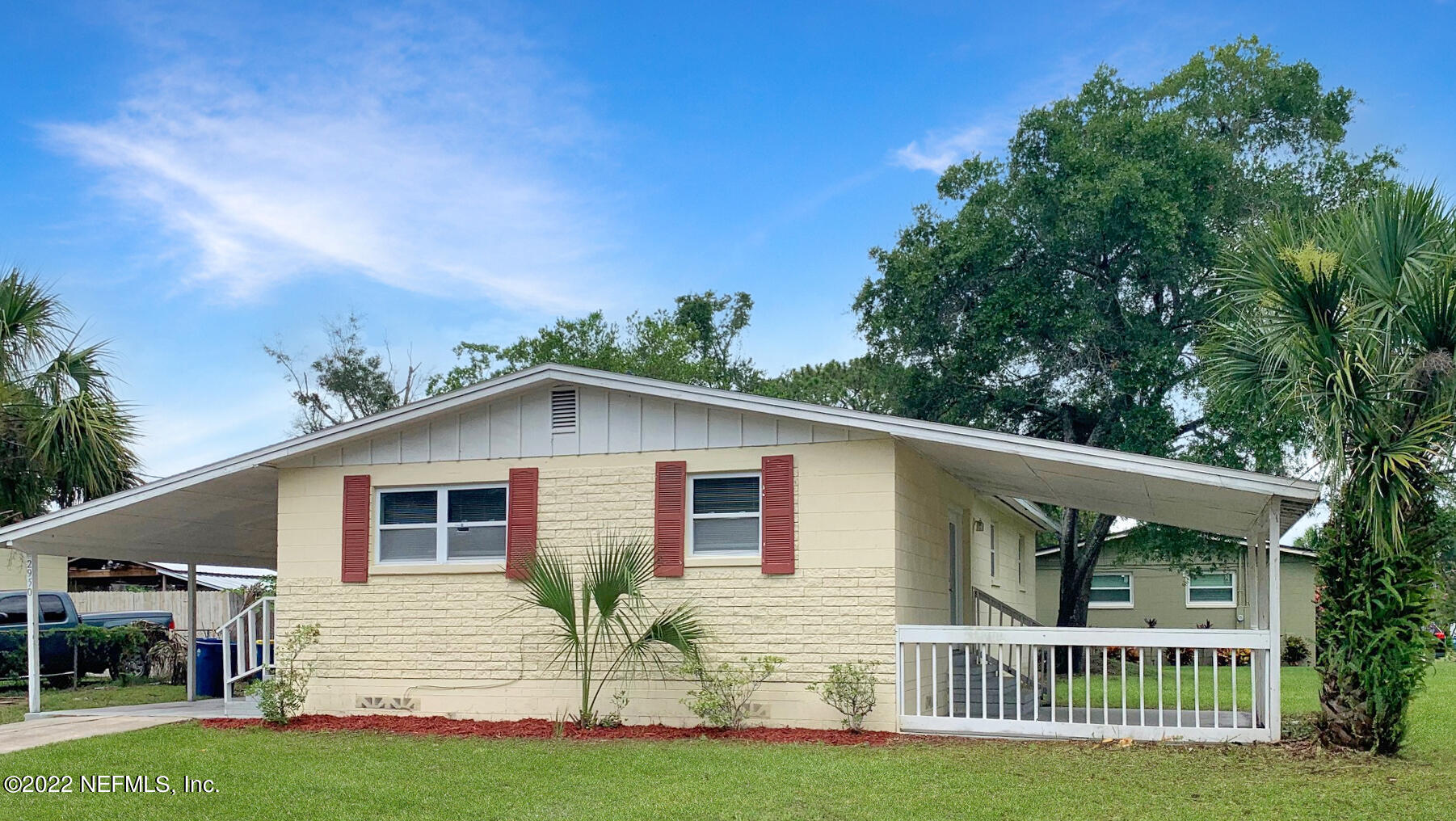2950 Mansion Road Jacksonville, FL 32277 - Photo 2 of 30 a view of a house with a yard and potted plants
