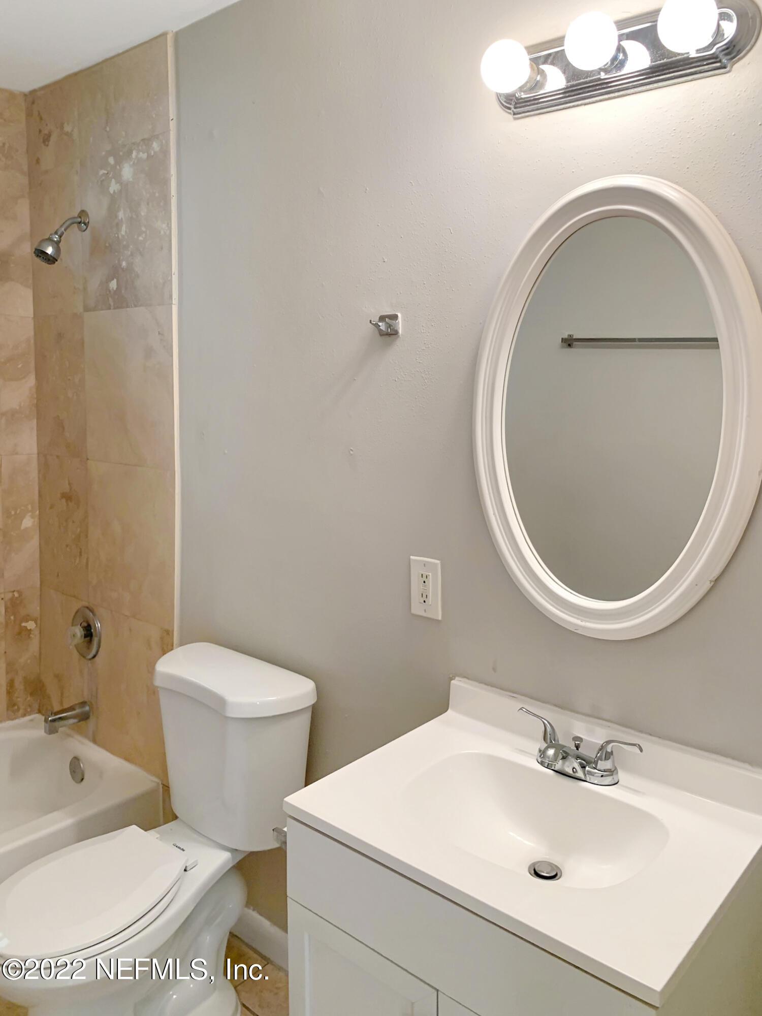 2950 Mansion Road Jacksonville, FL 32277 - Photo 21 of 30 a bathroom with a sink a toilet and a mirror