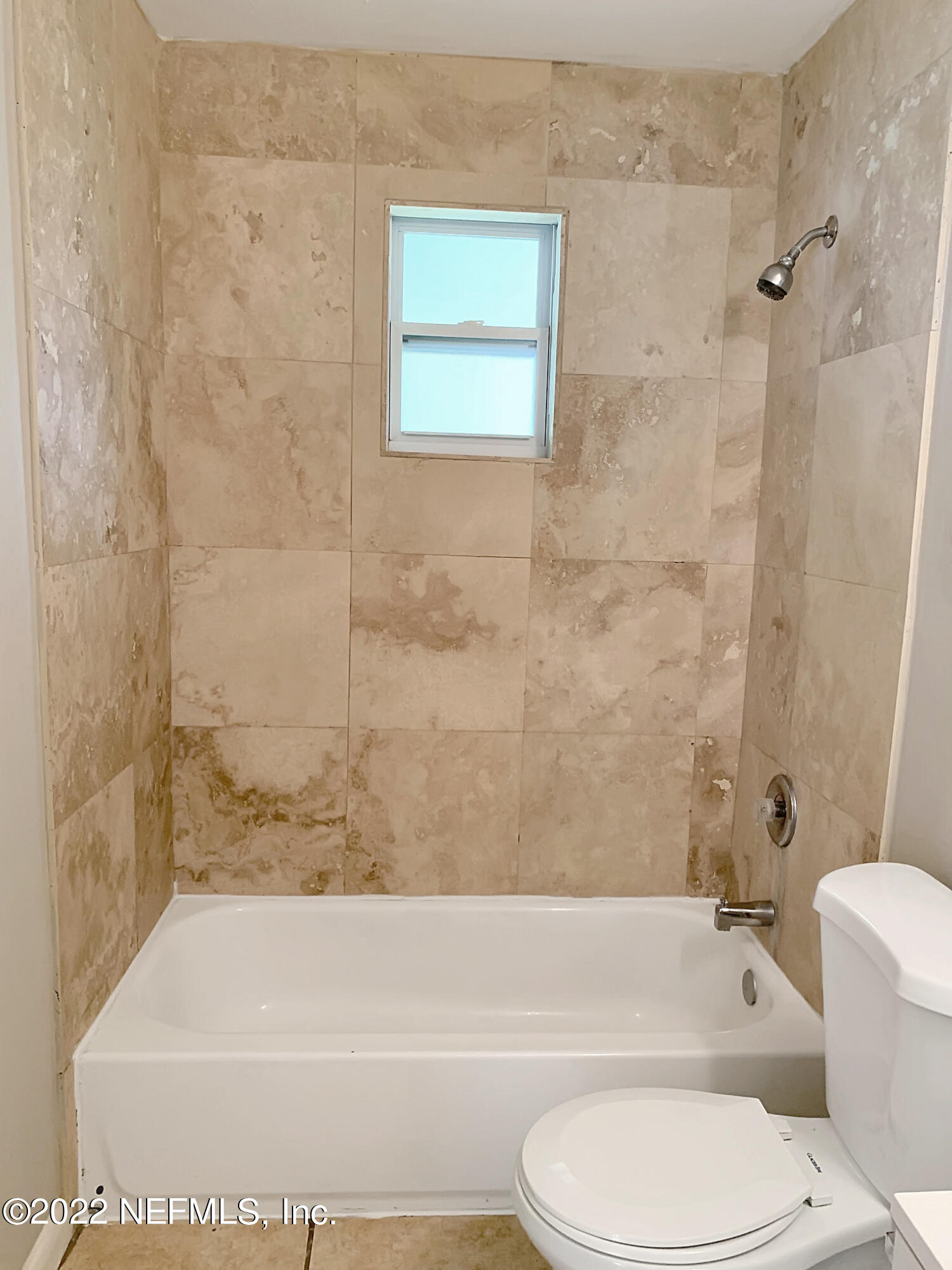 2950 Mansion Road Jacksonville, FL 32277 - Photo 22 of 30 a bathroom with a toilet and a bath tub