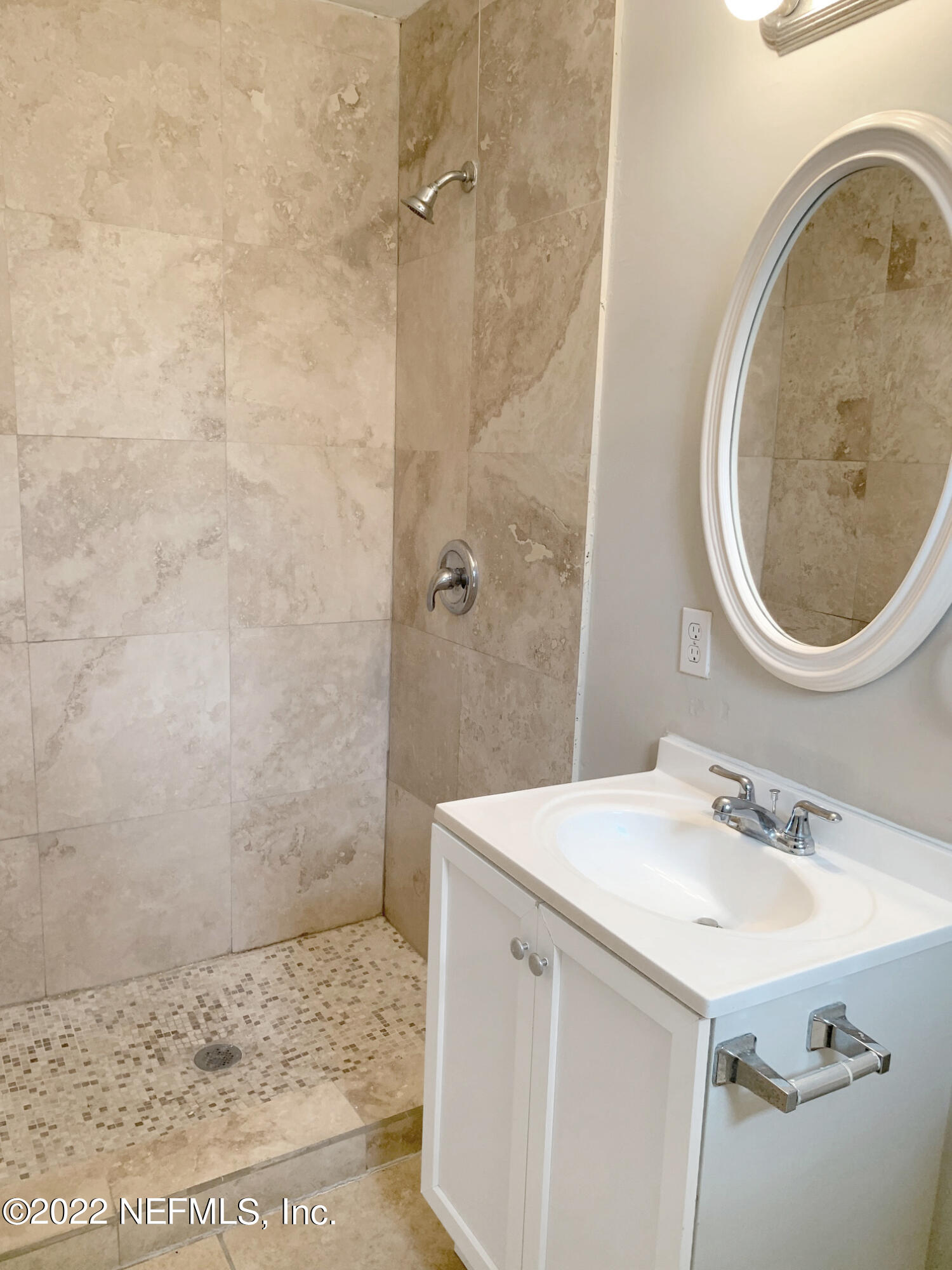 2950 Mansion Road Jacksonville, FL 32277 - Photo 30 of 30 a bathroom with a sink a vanity and a mirror