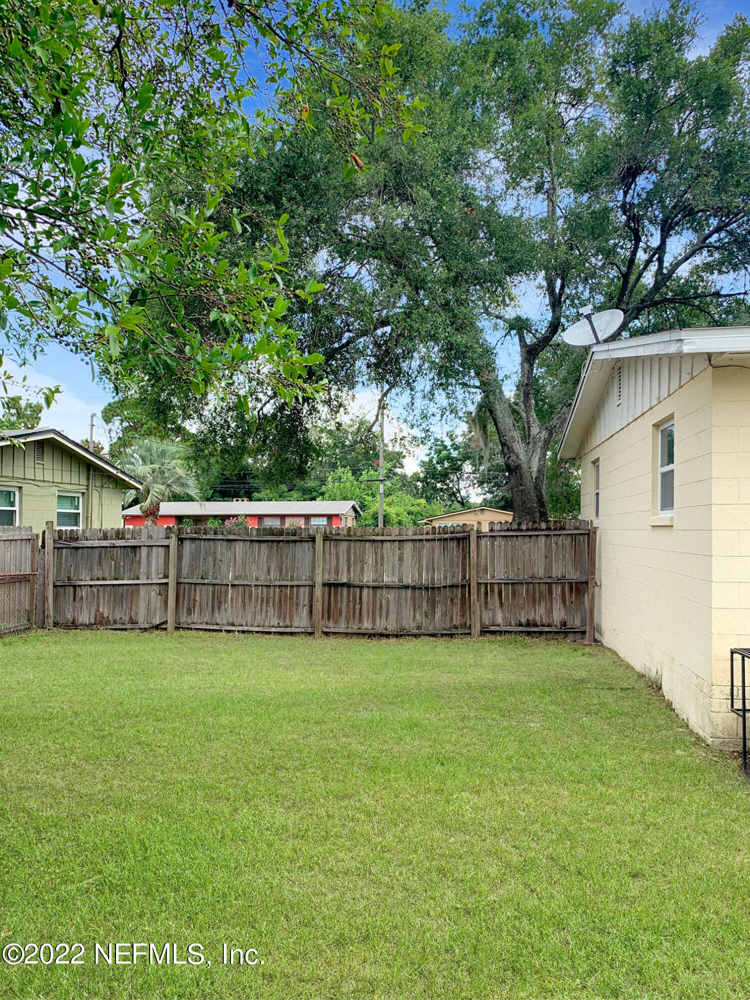 2950 Mansion Road Jacksonville, FL 32277 - Photo 9 of 30 a view of a house with a yard and a large tree